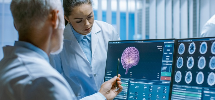 two doctors examining scan of patient's brain