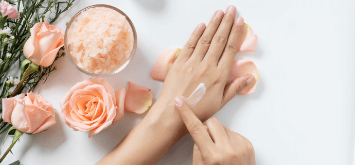 Woman rubbing rose beauty products into her hands