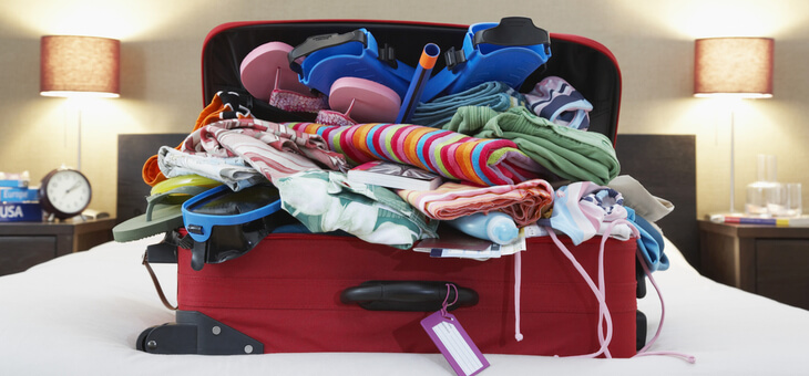 suitcase overfilled with clothes