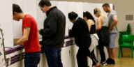 people voting at voting booth on election day