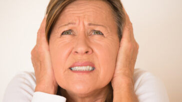 woman covering ears with hands