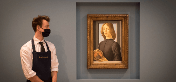 Curator looking at the painting Young Man Holding A Roundel, by Renaissance master Sandro Botticelli,