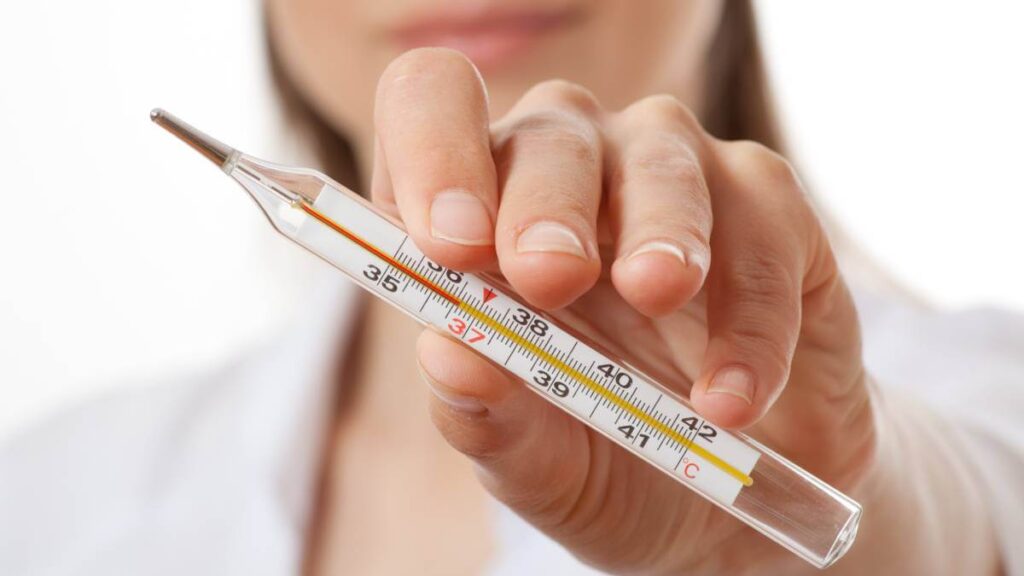 Woman holding a thermometer
