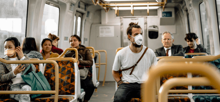 passengers on train wearing masks