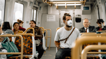 passengers on train wearing masks