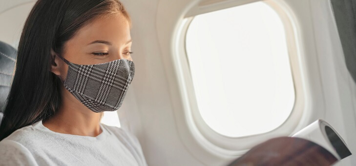 woman wearing mask on flight