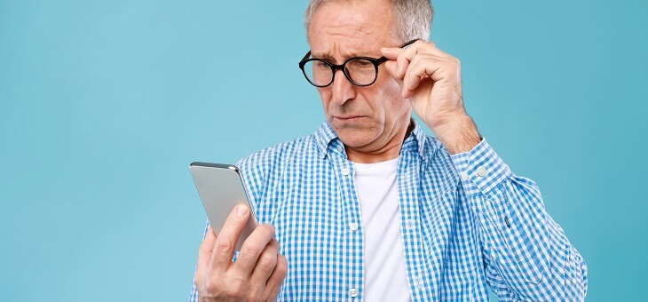 man looking at his phone with skepticism