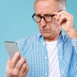 man looking at his phone with skepticism