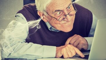 frustrated senior man using laptop