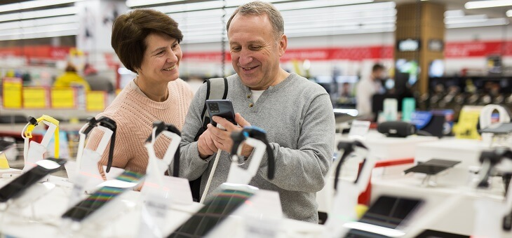 middle aged couple shopping for electronics