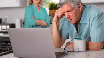 man looking frustrated at laptop