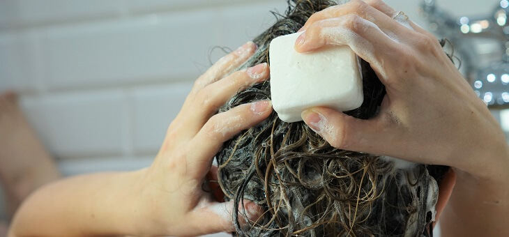 woman washing hair with shampoo bar