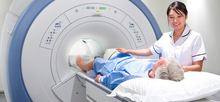 nurse speaking to man as he enters MRI chamber