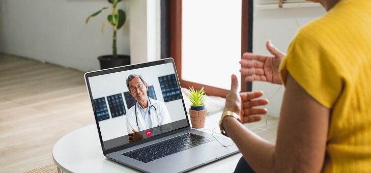woman conducting telehealth appointment with doctor