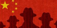silhouettes of spies against chinese flag backdrop