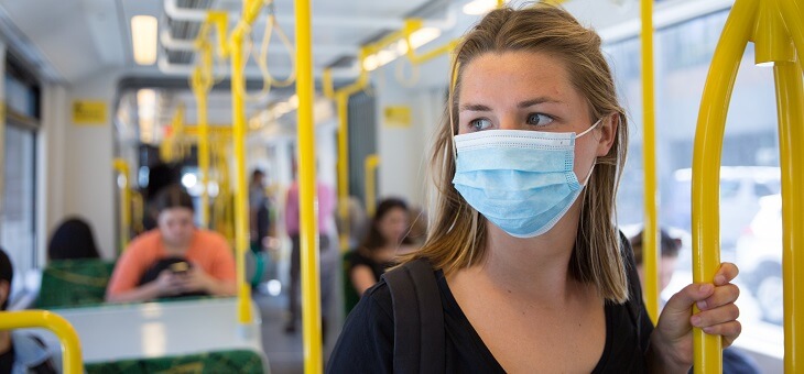 woman on tram wearing face mask