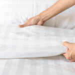 woman changing bed linen