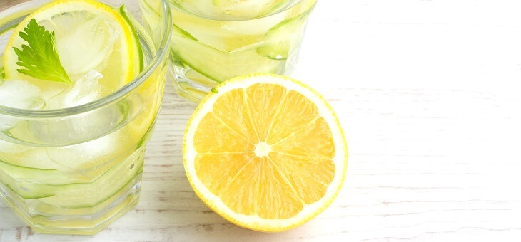 glass of water with lemon in it