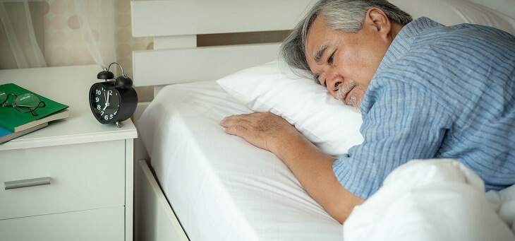 man lying awake in bed