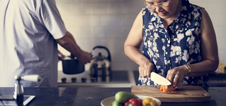 older couple cooking in kitchen