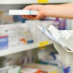 pharmacist filling prescription in medicine shortage
