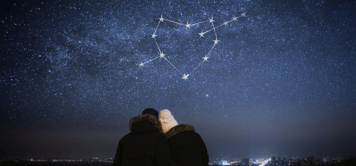 Couple sitting under a loveheart star sign