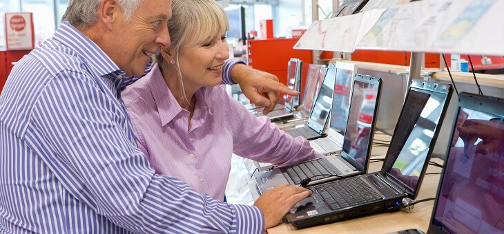 middle aged couple buying a laptop