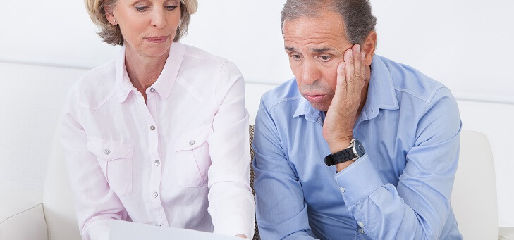 man and woman looking shocked at energy bill