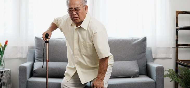 man struggling to stand after sitting for too long
