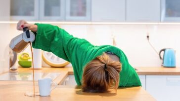 woman asleep on desk as she is tired all the time