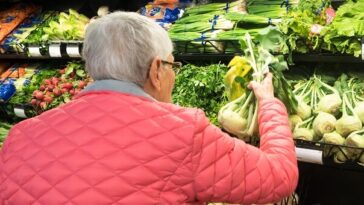 elderly woman shopping for vegetables