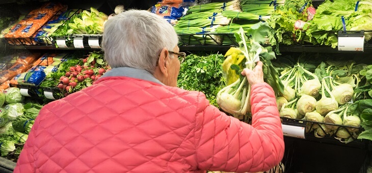 elderly woman shopping for vegetables
