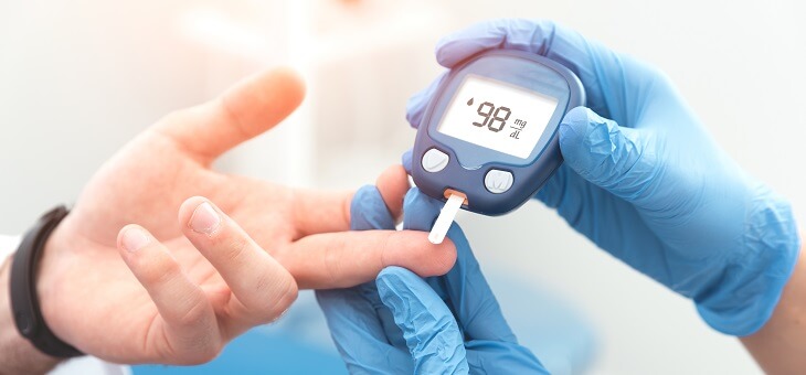 person measuring blood glucose levels