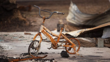 burnt child's bike after bushfire