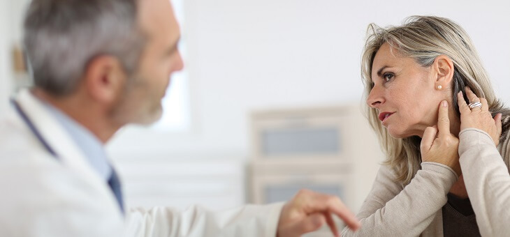 woman speaking with doctor about ear pain