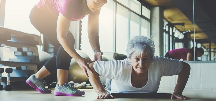 older woman doing strength training to slow ageing process