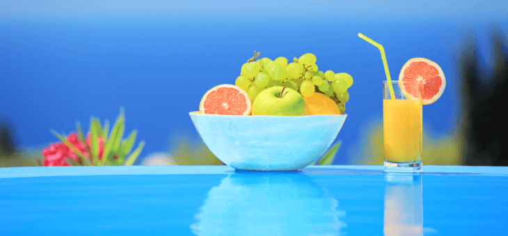 A bowl of fruit and a juice