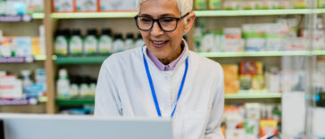 pension work test mature pharmacist working in modern pharmacy