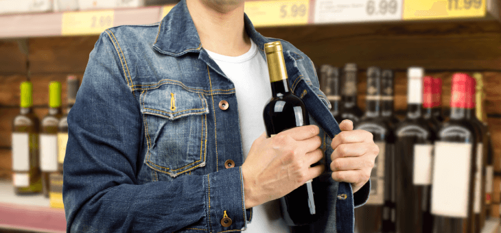 man stealing a bottle of wine