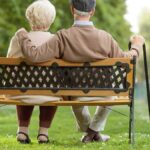 pensioners sitting on park bench