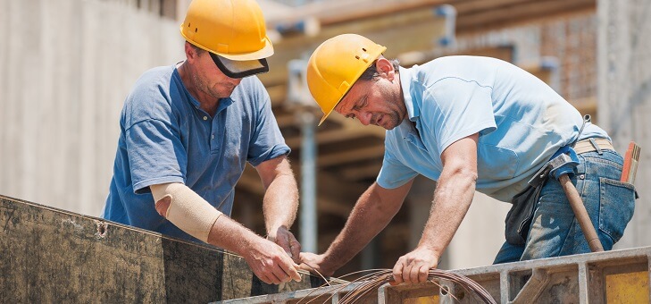 two men working on construction site