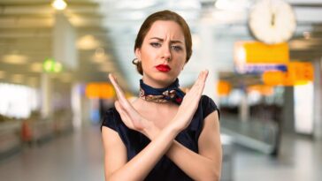 annoyed flight attendant crossing arms