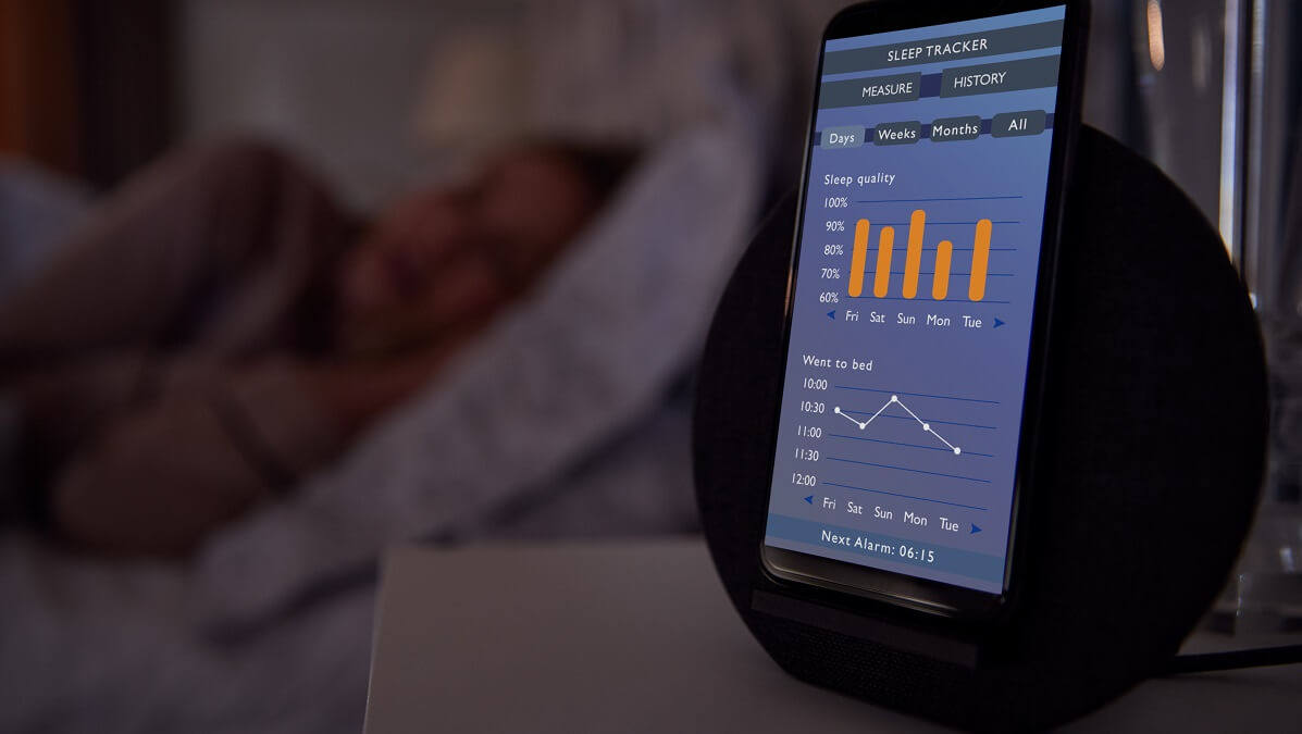 phone beside bed showing sleep tracking app