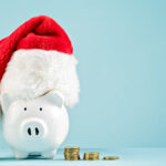 piggy bank in xmas hat representing christmas savings