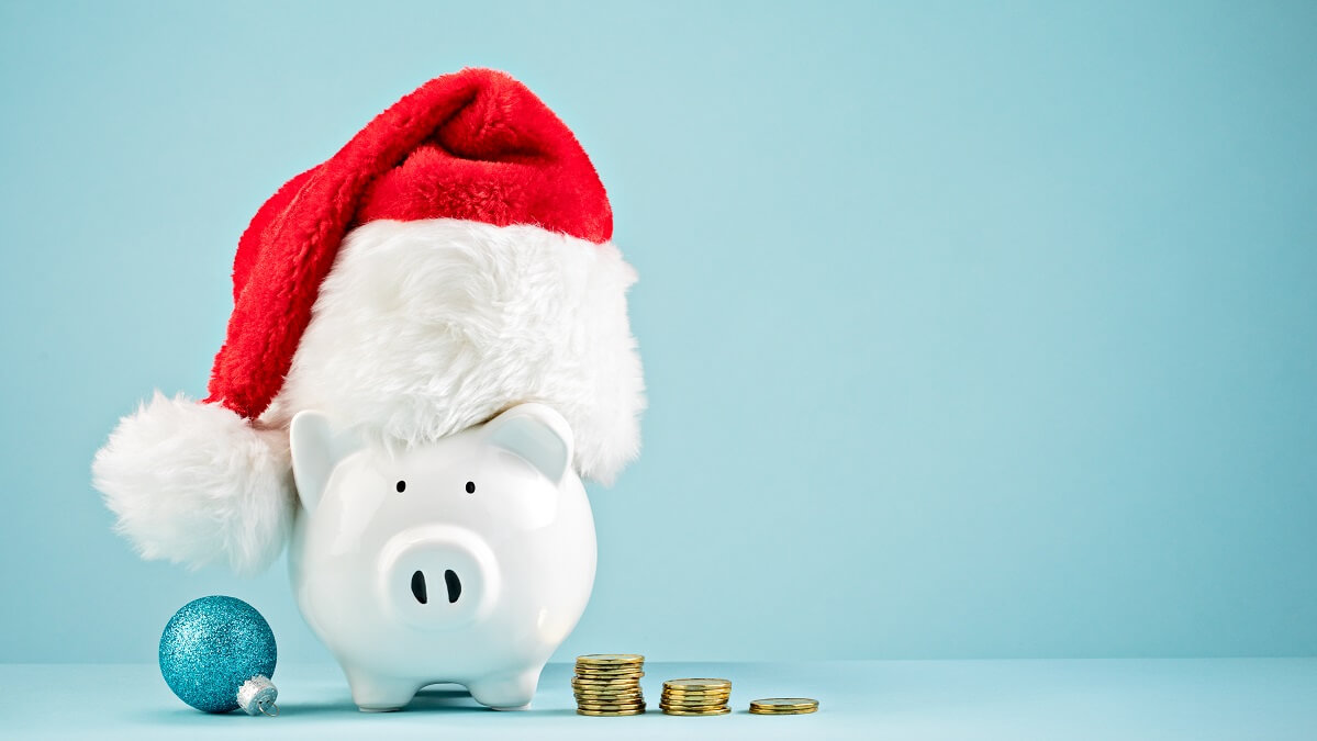 piggy bank in xmas hat representing christmas savings