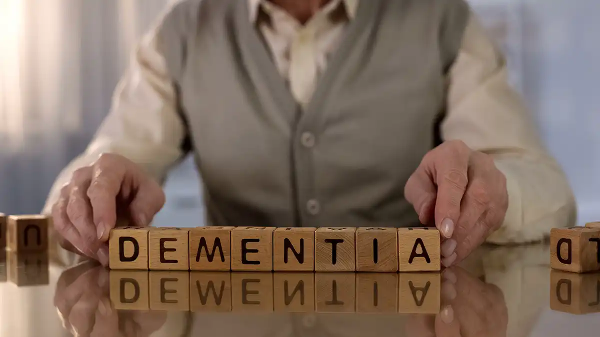 man with word blocks spelling dementia to reference health issues that mimic dementia