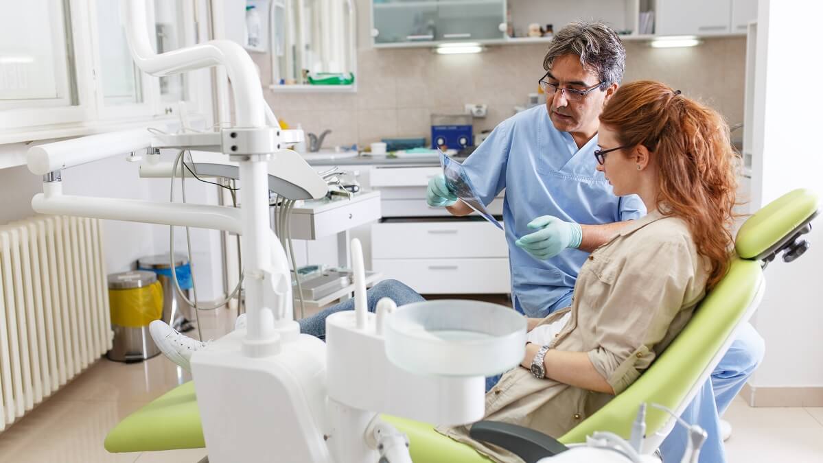 woman speaking with dentists