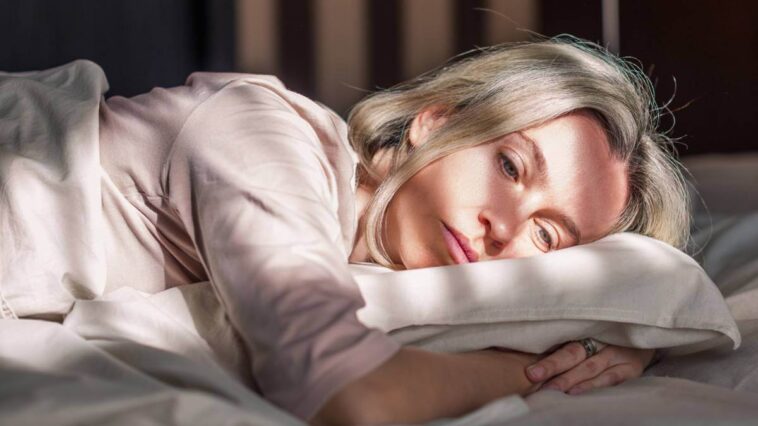 Woman waking up after a bad night's sleep