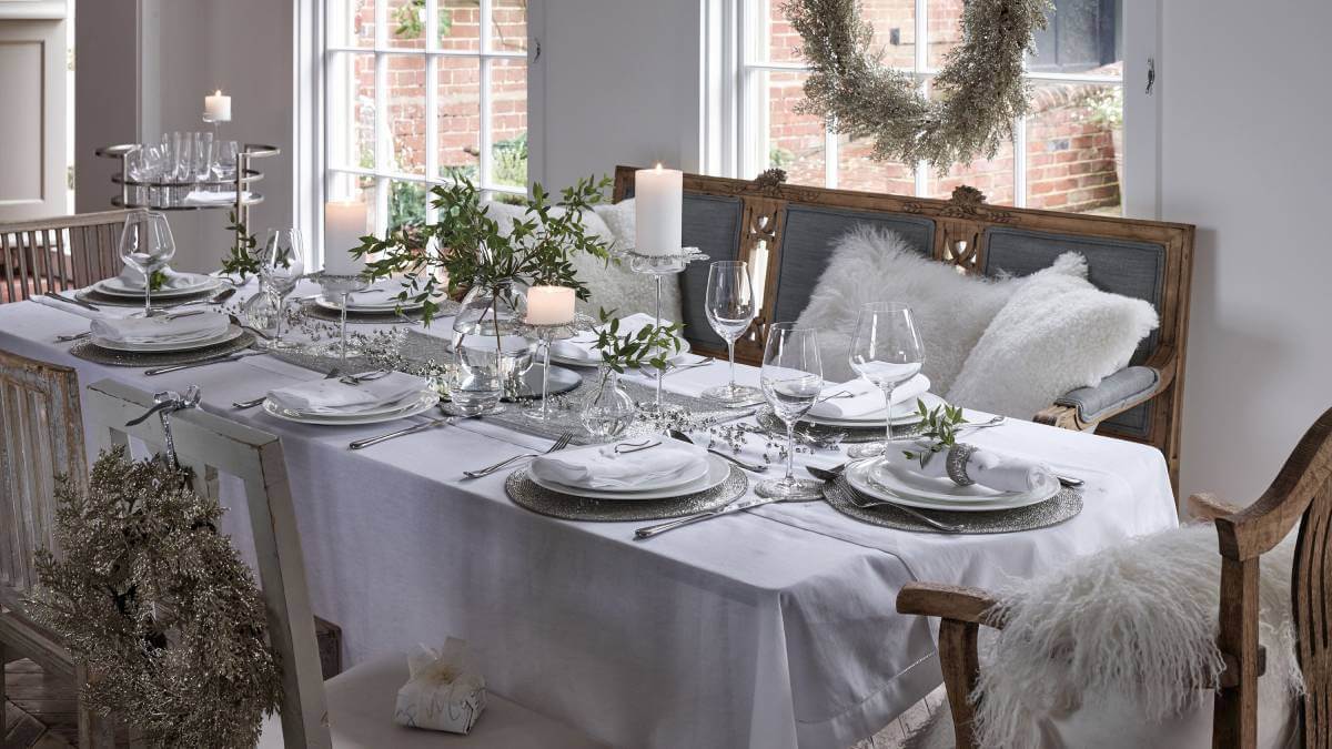 A beautifully styled Christmas table with a white tablecloth