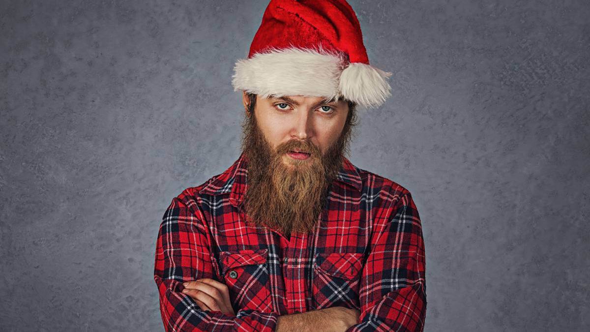 Man looking miserable in a santa hat